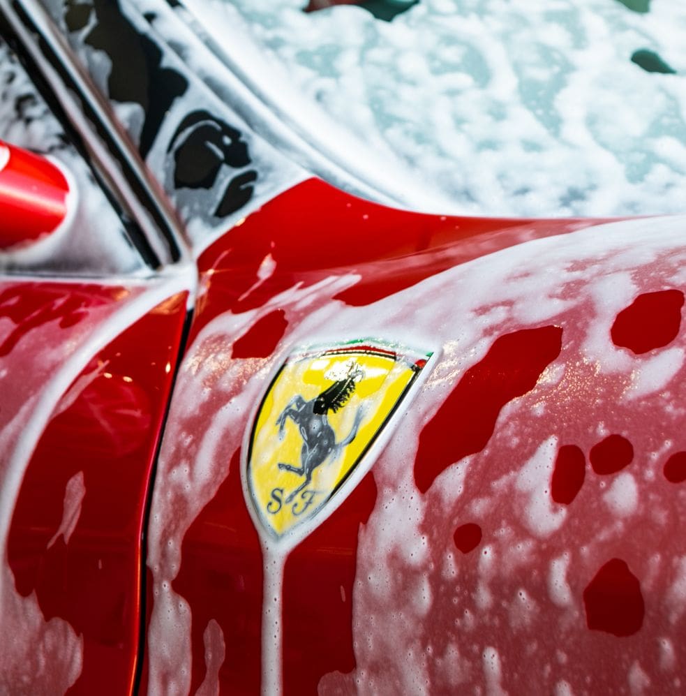 Ferrari badge with car shampoo over it